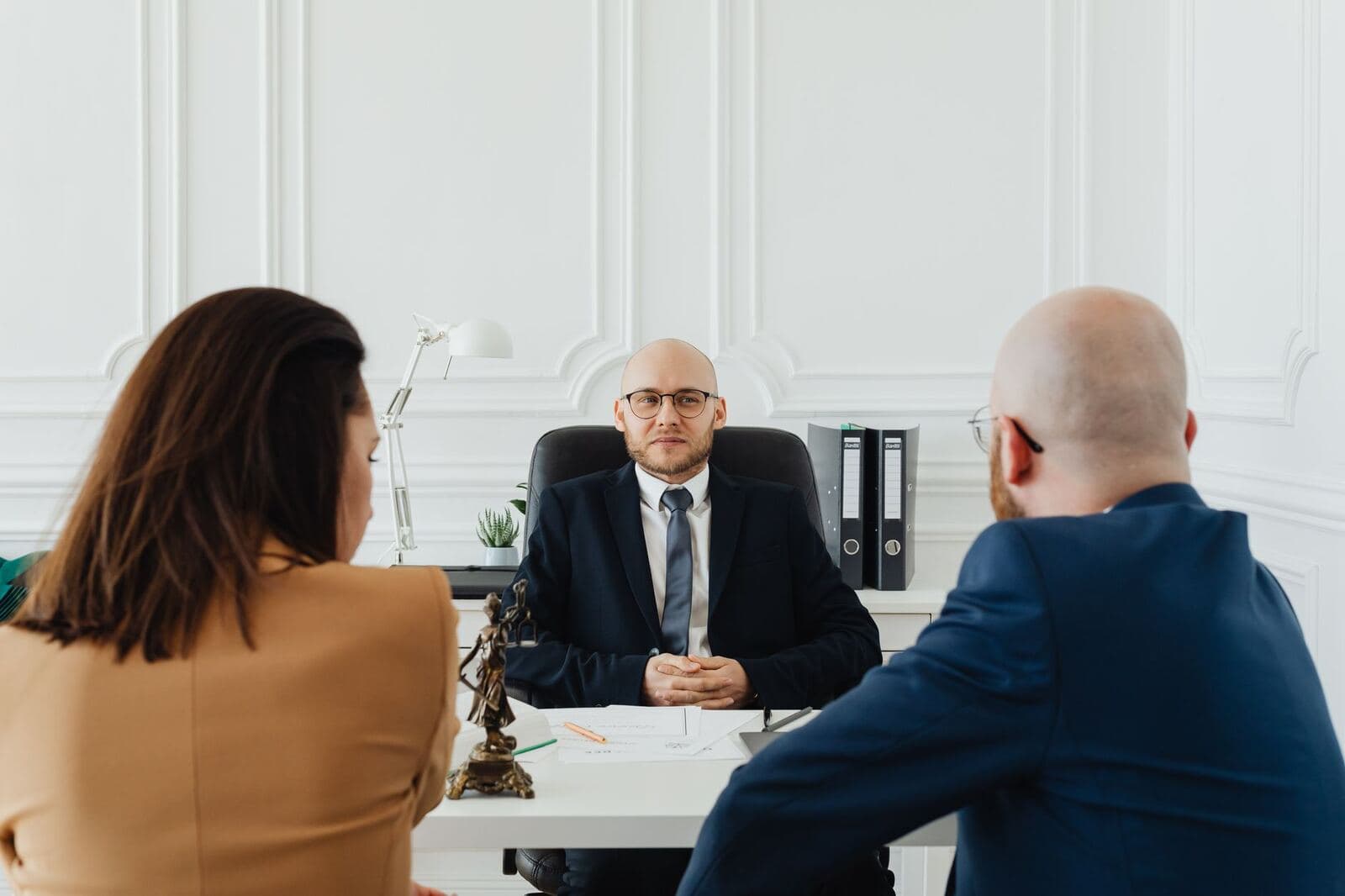 Attorney meeting with a client across an office desk