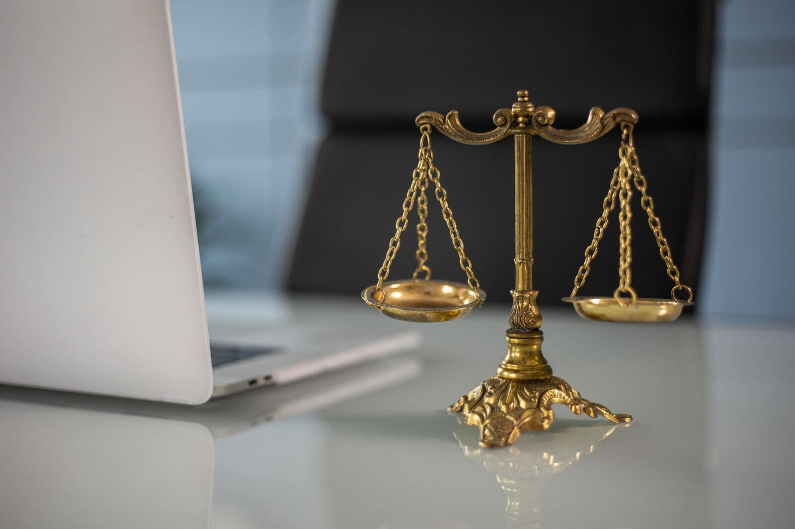 Scales of justice on a business lawyer's office desk
