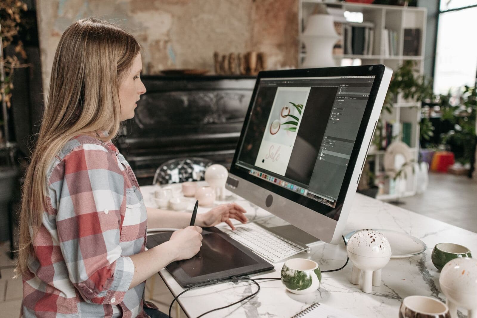Designer working on layouts at a creative studio desk