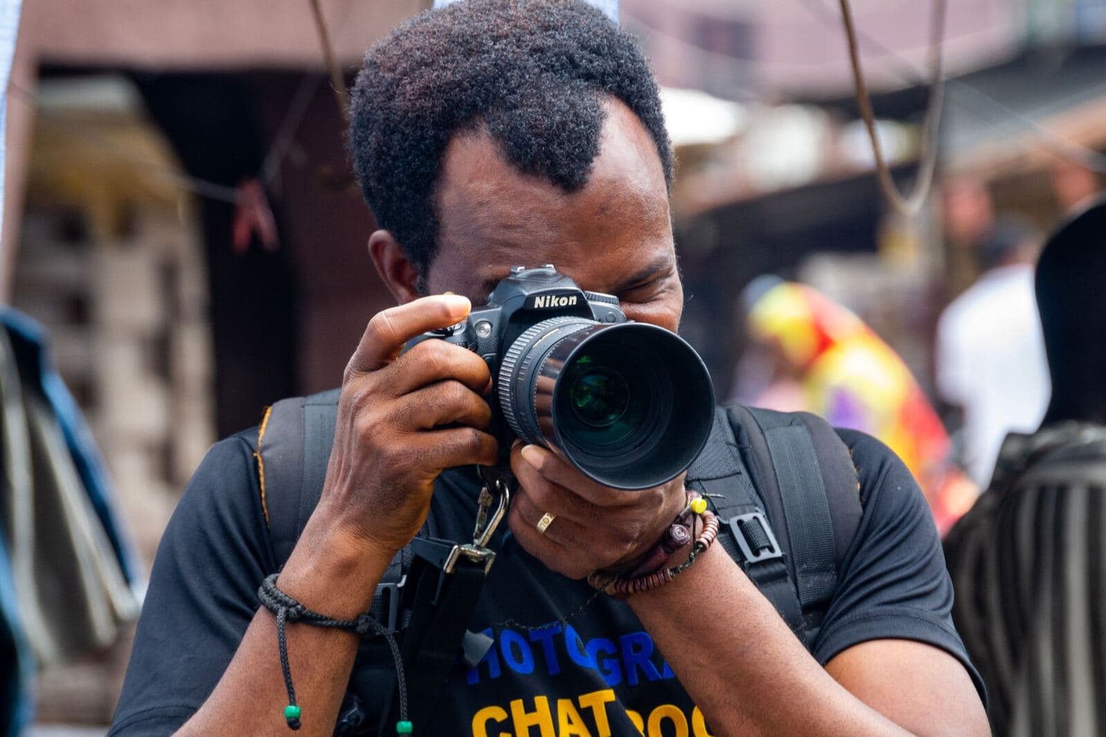 Photographer composing a shot through a professional camera